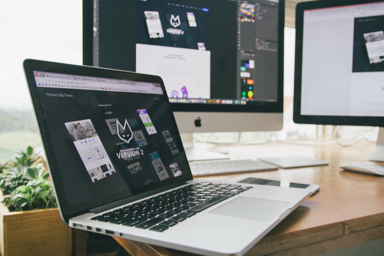 Crafting Captivating Headlines: Your awesome post title goes here A stylish workspace featuring a laptop and monitors displaying design software.